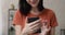 Woman using smart phone laughs over received message closeup view