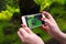 Woman using a smart phone to take a photo of aquarium