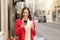 Woman using a smart phone in winter walking in the street