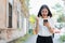 Woman using smartphone for the application and showing a happy gesture.