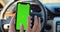 Woman using smartphone with green screen chroma key inside car. Concept: direction of travel, address search, message
