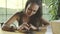 Woman using smartphone and smiling in cafe. Beautiful young casual female working on mobile phone.