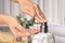 Woman using soap dispenser indoors