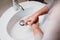 woman using soap and water for hands cleaning at home