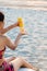 Woman using sun lotion on the beach