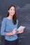 Woman using tablet in front of chalk drawing board