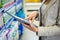 Woman using tablet pc in aisle