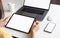 Woman using tablet screen blank and laptop on the table mock up to promote your products.