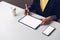 Woman using tablet screen blank and smartphone on the table mock up to promote your products.