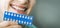 Woman using teeth whitening shade guide. tooth bleaching. banner copy space