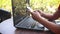 Woman using telephone front of her laptop, busy working woman.