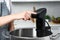 Woman using thermal immersion circulator in kitchen, closeup. Sous vide cooking