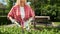 Woman using trimming shears while working at garden