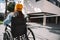 Woman using wheelchair on street