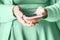 Woman using white smartphone. Mint green 2020