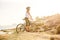 Woman on vacation biking at beach