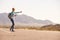 Woman On Vacation Hitchhiking Along Country Road