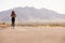 Woman On Vacation Hitchhiking Along Country Road