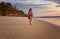 Woman on vacation walking along beach