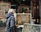 woman in Venice looking at the paintings in the window