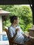 Woman In Veranda With Glass Of Water