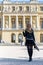 Woman at Versailles Palace. Young french dressed tourist girl admiring the views. Portrait soft bokeh background