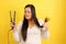 Woman with very long straight hair combs her hair with a straightener worried about the damage it causes to split ends