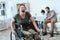 Woman veteran in wheelchair returned from army. A woman in a wheelchair is in pain. She`s in military uniform.