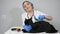 Woman veterinarian cleaning black long haired cat on table