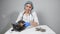 Woman veterinarian combing a gray cat with a brush