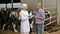 Woman veterinarian talking to farmer