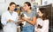 Woman veterinarian talking to girls adopting kittens