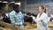 Woman veterinarian talking to goat breeder