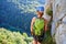 Woman on via ferrata at Vadu Crisului, Romania, admiring the view towards Crisul Repede river and the surrounding forest