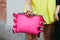 Woman with vibrant pink leather bag, big ring and yellow dress before Fendi fashion show, Milan Fashion Week