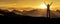 Woman in victory pose at sunrise on a mountain peak