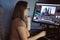Woman video creator mounts video at desktop. Home workstation