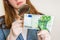 Woman viewing counterfeit banknote with magnifying glass