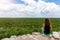 Woman views over the rain forest of Yucatan, Mexico