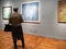 Woman views paintings in New Tretyakov Gallery
