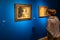 Woman views pictures in New Tretyakov Gallery