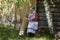 A woman in the village is engaged in housekeeping. The girl is carrying buckets of water from a clean source.