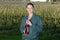 woman vineyard worker holding bottle wine