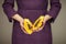 Woman in violett 50`s dress hands holding some papayas