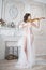 Woman with violin in white peignoir. Boudoir. seductive