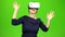 Woman in virtual glasses is watching an interesting film. Green screen