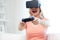 Woman in virtual reality headset with controller