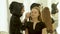 Woman visagiste doing makeup eyebrows on face young model in beauty studio. Woman visagiste coloring eyebrows on face