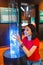 Woman visitor looking at Colorful plasma lamp experiment in physics museum