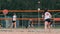 Woman volleyball serve. Woman getting ready to to serve the volleyball while standing on the beach slow motion.